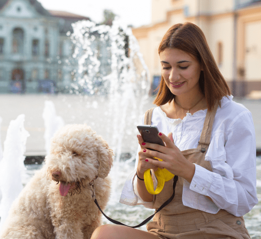 woman dog cell phone fountain
