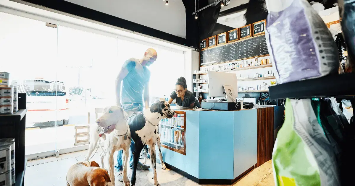 A patron at a pet store with his dogs