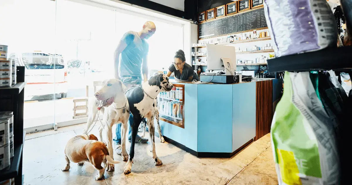 Man at pet store with dogs