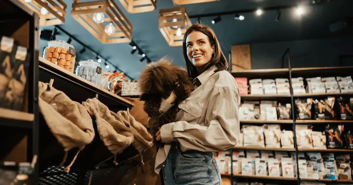 Woman at a pet shop holding her dog