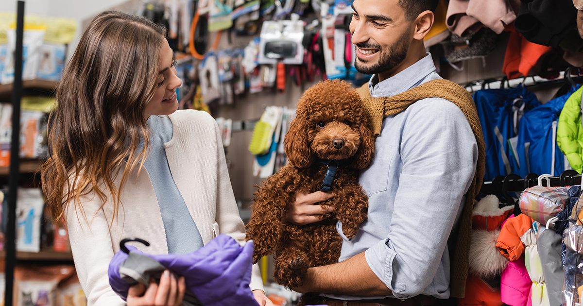Woman and man with dog at pet store